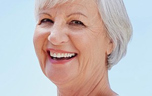 Senior woman with natural looking implant denture
