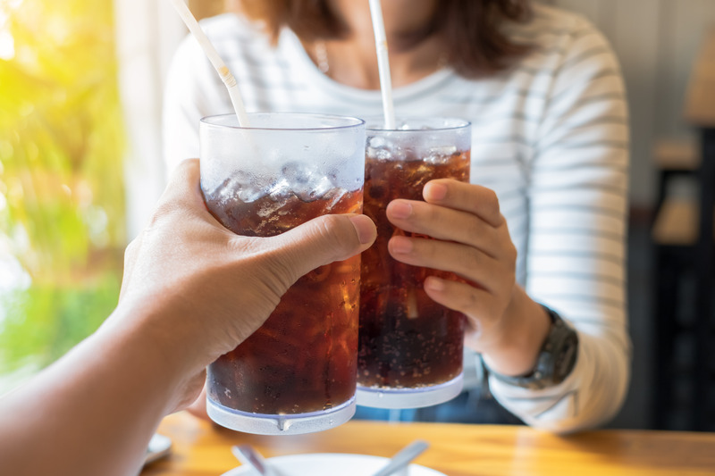 Patient drinking a soda that could change their tooth color